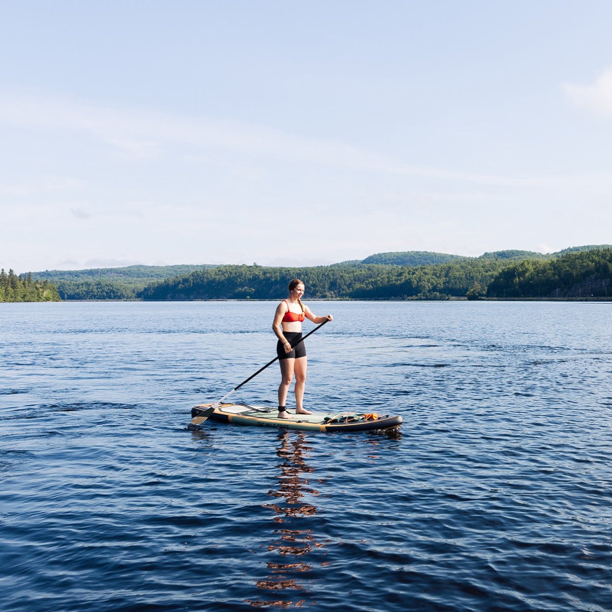 women doing paddleboard on a lake